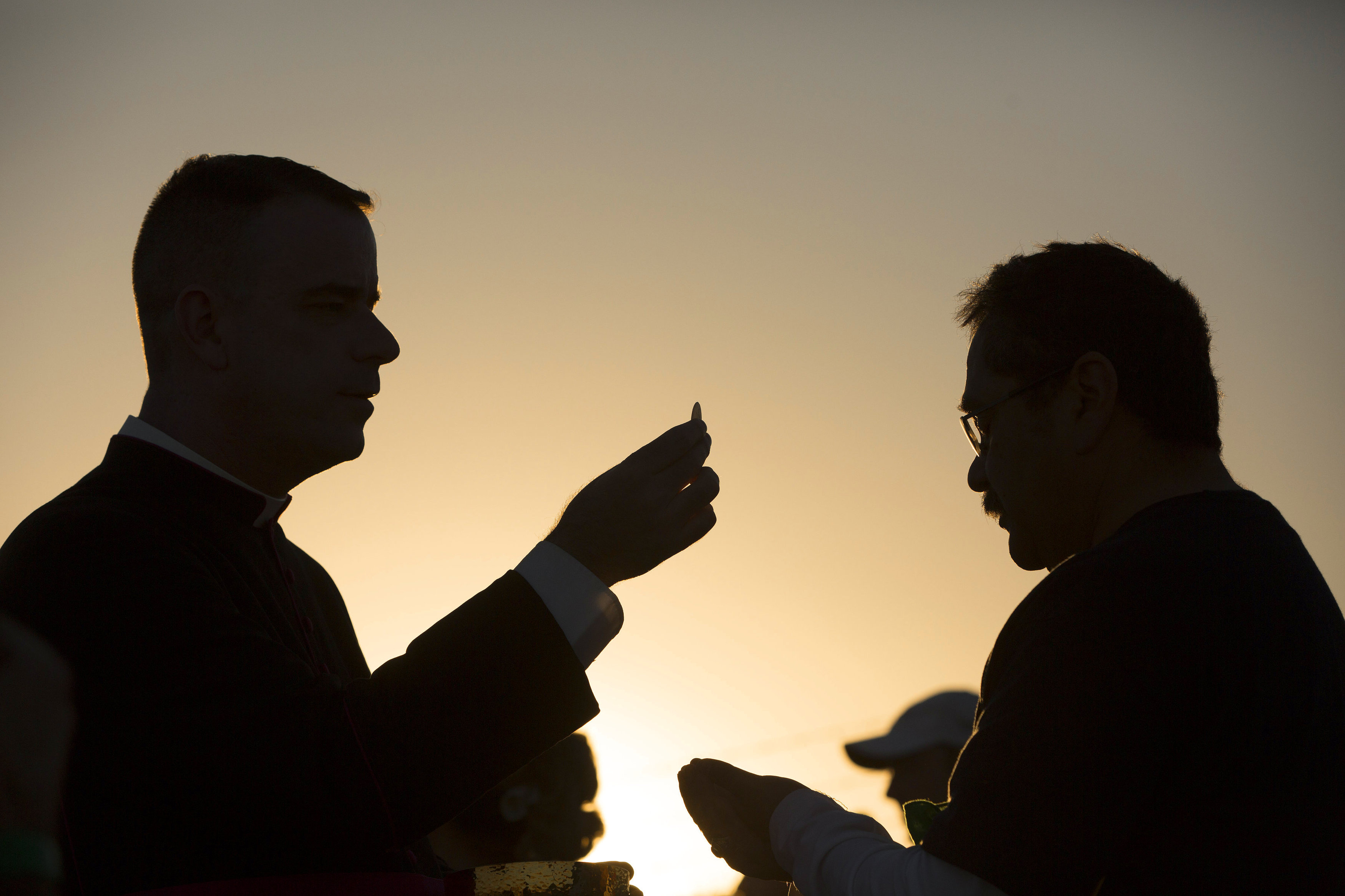 A man receives Communion on the U.S. side of the border in El Paso, Texas, Feb. 17, 2016, as Pope Francis celebrated Mass in Ciudad Juárez, Mexico. (CNS/Nancy Wiechec)