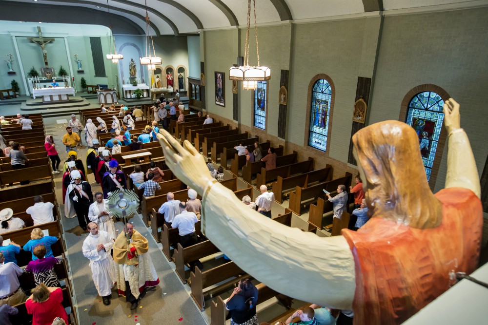 Fr. Michael Champagne carries the Blessed Sacrament at St. John Francis Regis in Arnauldville, Louisiana, Aug. 15, 2016, on the feast of the Assumption. (CNS photo/Tim Mueller)