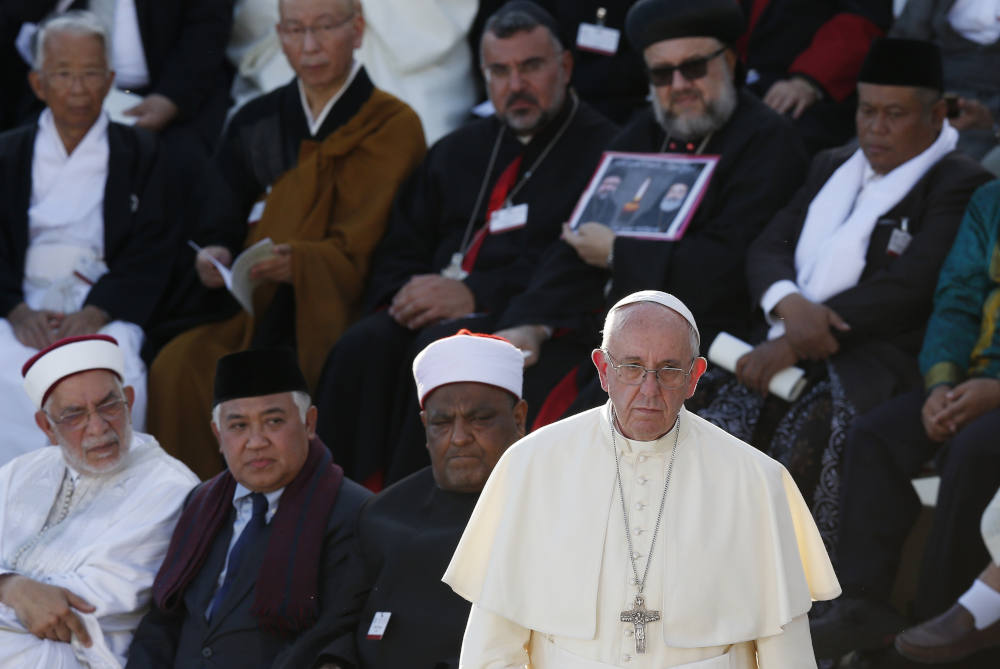 Pope Francis walks forward to speak during an interfaith peace gathering outside the Basilica of St. Francis in Assisi, Italy, Sept. 20, 2016. The Vatican announced June 17 that it will host faith leaders in October to prepare a statement ahead of the COP