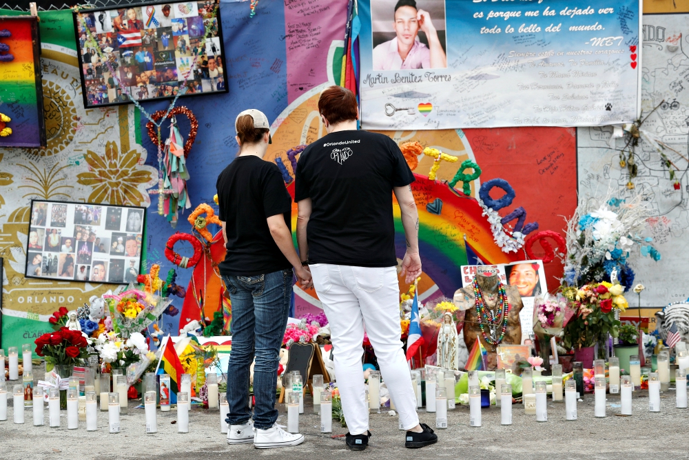 People visit the memorial outside the Pulse nightclub in Orlando, Florida, June 12, 2017, the one-year anniversary of the mass shooting there. (CNS/Reuters/Scott Audette)