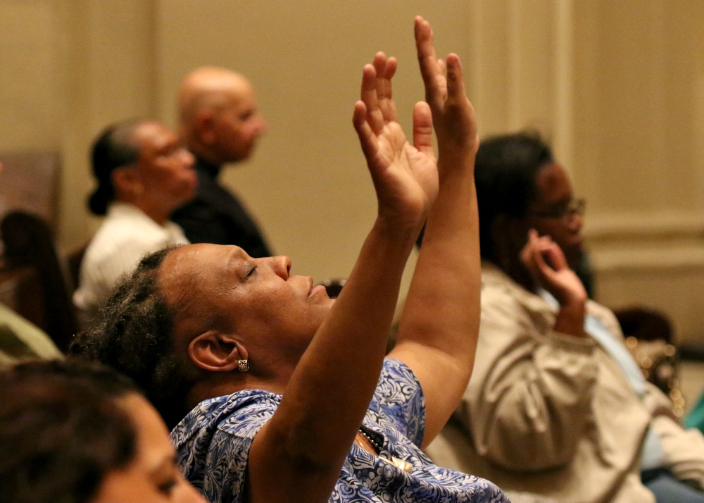 A woman prays during a Mass for solidarity and peace Aug. 24 at St. James Cathedral Basilica in Brooklyn, New York, The liturgy was held in response to the violent and deadly white supremacist demonstrations in Charlottesville, Virginia.