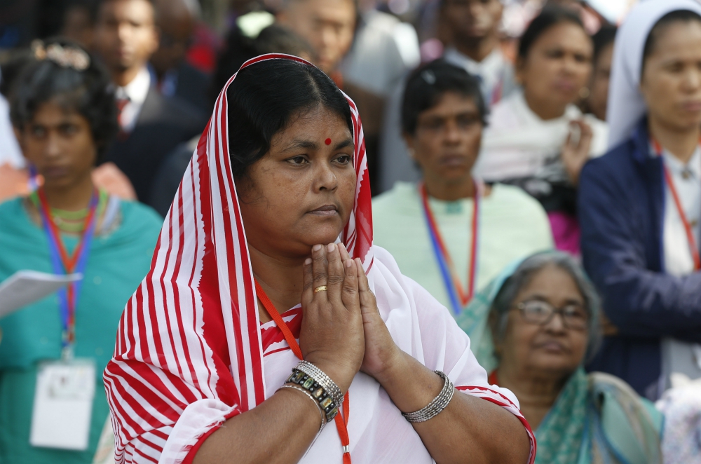 A woman prays as Pope Francis celebrates Mass and the ordination of priests in Suhrawardy Udyan park in Dhaka, Bangladesh, Dec. 1. (CNS/Paul Haring)