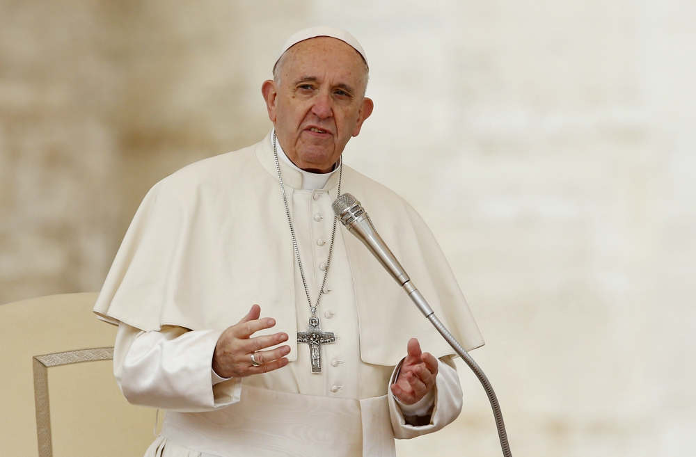 Pope Francis leads a prayer during his general audience in St. Peter's Square at the Vatican April 11. (CNS/Paul Haring) 