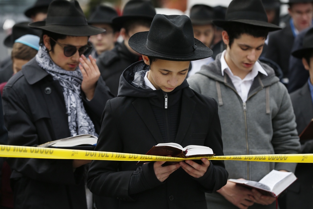 Students from the Yeshiva School pray in front of the Tree of Life synagogue Oct. 29, two days after a mass shooting at the Pittsburgh synagogue. (CNS/EPA/Jared Wickerham)