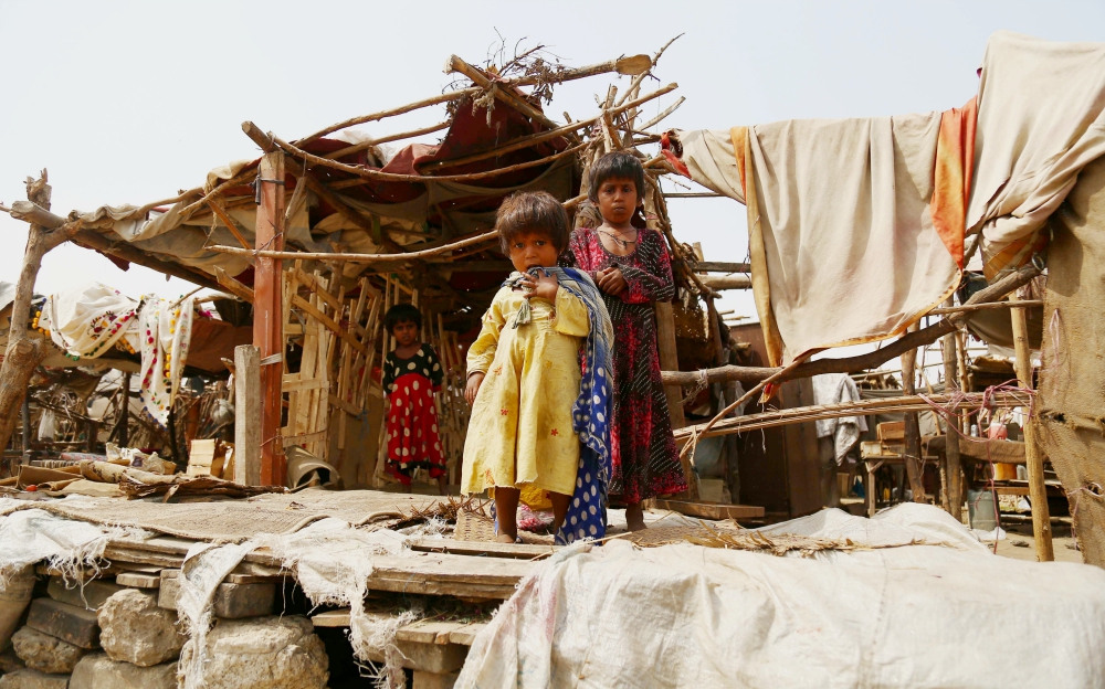 Pakistani children stand outside their makeshift home Oct. 16, 2018, near Karachi. (CNS/EPA/Shahzaib Akber)