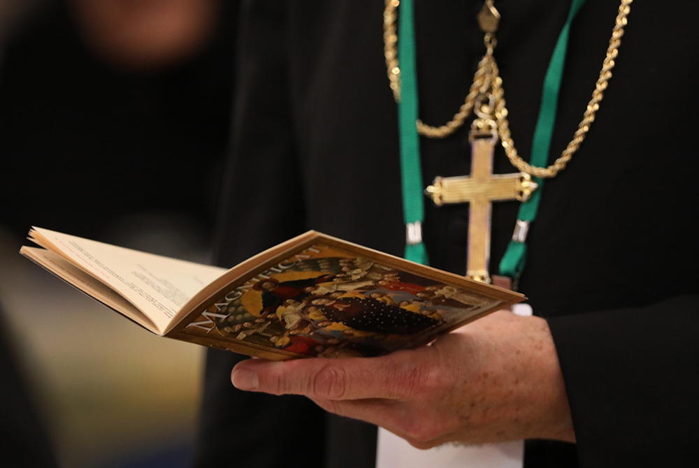 A bishop prays on the first day of the annual general assembly of the U.S. bishops' conference June 11, 2019, in Baltimore. (CNS /Bob Roller) 