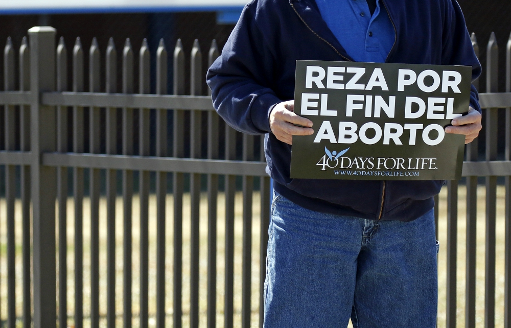 A Spanish-language sign that reads, "Pray for the end of abortion," is seen at a vigil near the entrance to a Planned Parenthood center in Smithtown, New York, March 26. (CNS/Gregory A. Shemitz)