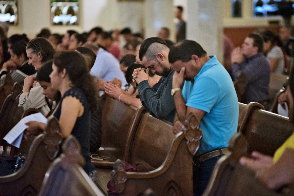 People pray during a healing Mass Aug. 7 at the Cathedral Shrine of the Virgin of Guadalupe in Dallas for the 31 victims killed in the mass shootings in El Paso, Texas, and Dayton, Ohio, Aug. 3 and 4. (CNS/The Texas Catholic/Jenna Teter)