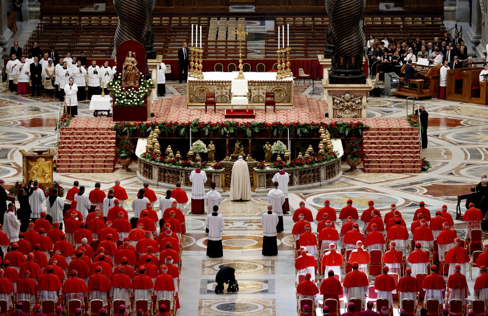 Pope Francis prays as he arrives for a consistory to create new cardinals in St. Peter's Basilica at the Vatican in June 2017. (CNS/Paul Haring)