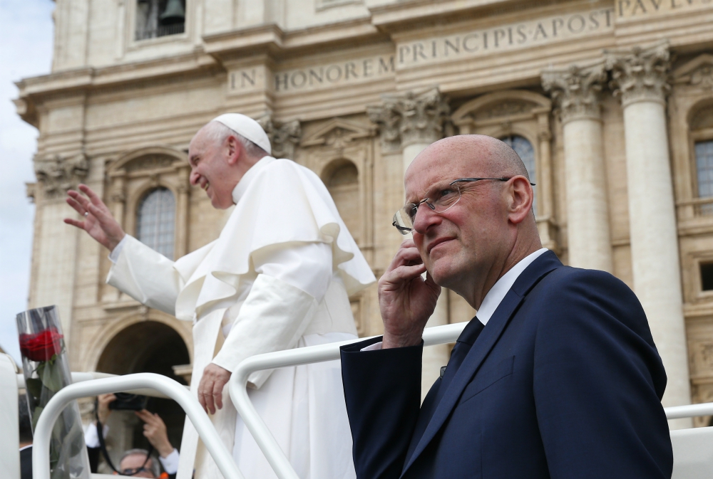 Domenico Giani, lead bodyguard for Pope Francis and head of the Vatican police force, keeps watch as the pope leaves his general audience in St. Peter's Square at the Vatican May 1. Pope Francis accepted Giani's resignation Oct. 14. (CNS/Paul Haring)