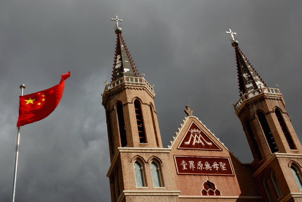 The Chinese national flag flies in front of a Catholic church in Huangtugang, China, in 2018. (CNS/Reuters/Thomas Peter)