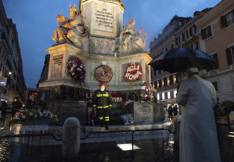 Pope Francis prays at the base of a tall Marian statue overlooking the Spanish Steps in Rome Dec. 8, the feast of the Immaculate Conception. (CNS/Vatican Media)