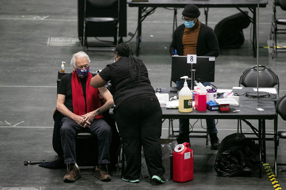 A man at the New York state COVID-19 vaccination site, the Jacob K. Javits Convention Center in New York City, receives a dose of the coronavirus vaccine Jan. 13. (CNS/Reuters/Brendan McDermid)