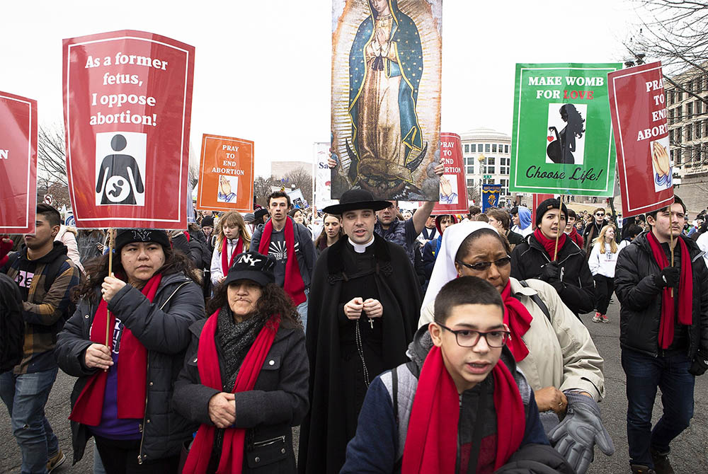 People walk up Constitution Avenue headed toward the U.S. Supreme Court while participating in the 47th annual March for Life Jan. 24, 2020, in Washington. The 2021 March for Life in Washington will be held virtually because of the coronavirus pandemic an