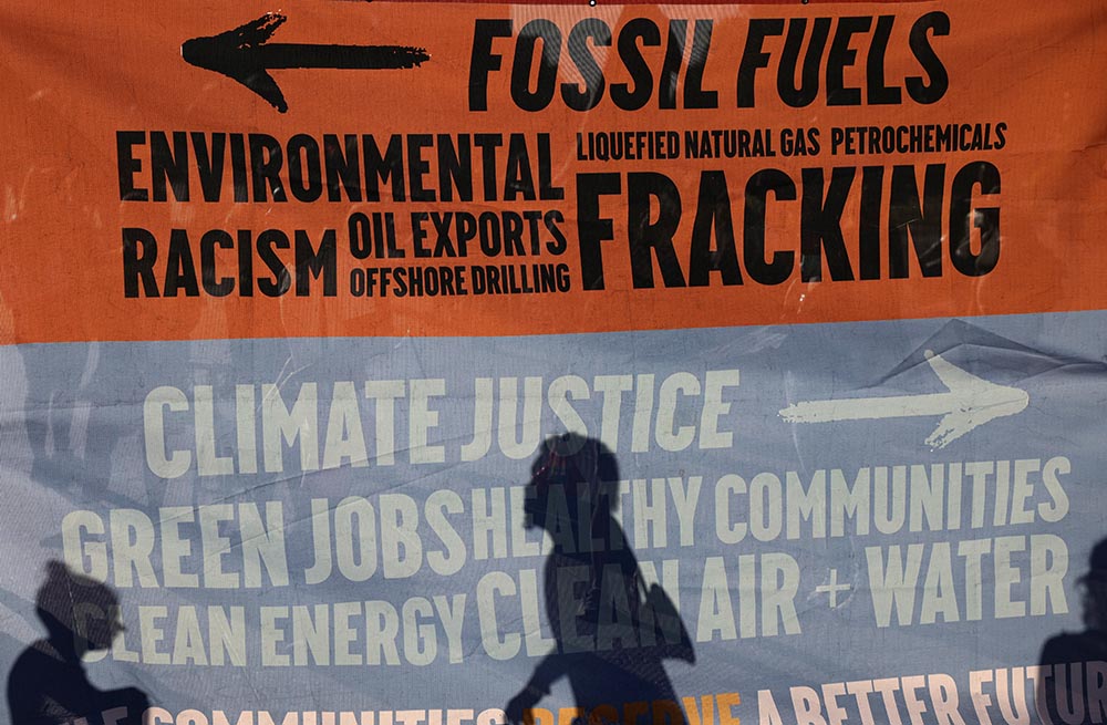 Environmental activists protest outside the White House in Washington June 30 to demand President Joe Biden stop fossil fuel projects and put "climate justice" at the heart of his infrastructure plans. (CNS/Reuters/Evelyn Hockstein)