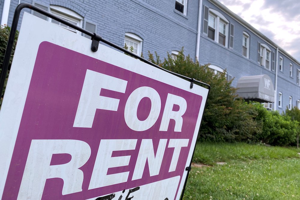 A "For Rent" sign is displayed in front of an apartment building June 20 in Arlington, Virginia. (CNS/Reuters/Will Dunham)