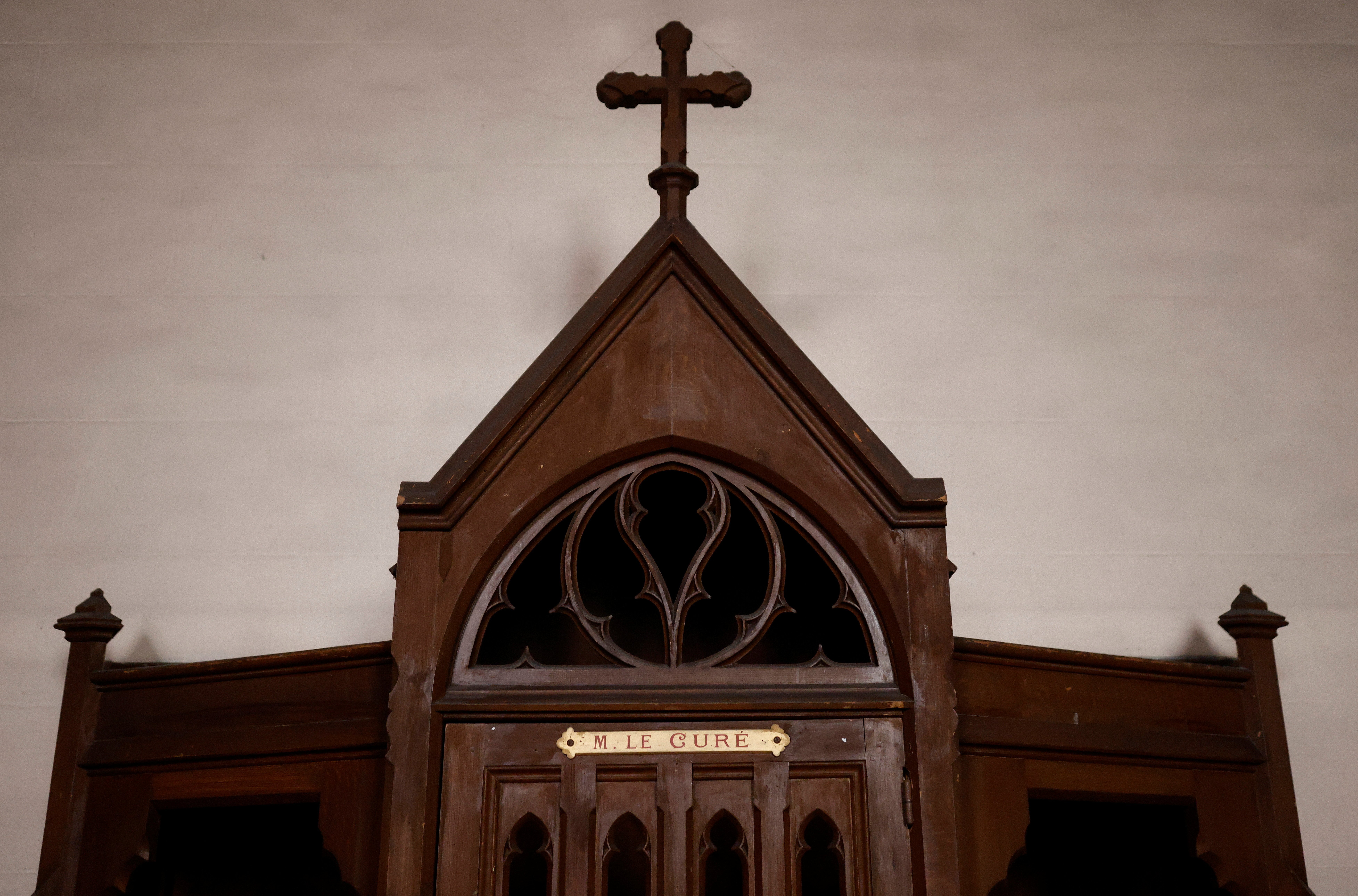 A confessional on which is written: "M. the Priest" is pictured in a Catholic church near Nantes, France, Oct. 5, 2021. Church and government leaders in France are at odds over whether priests should be required to report the abuse of minors if they learn