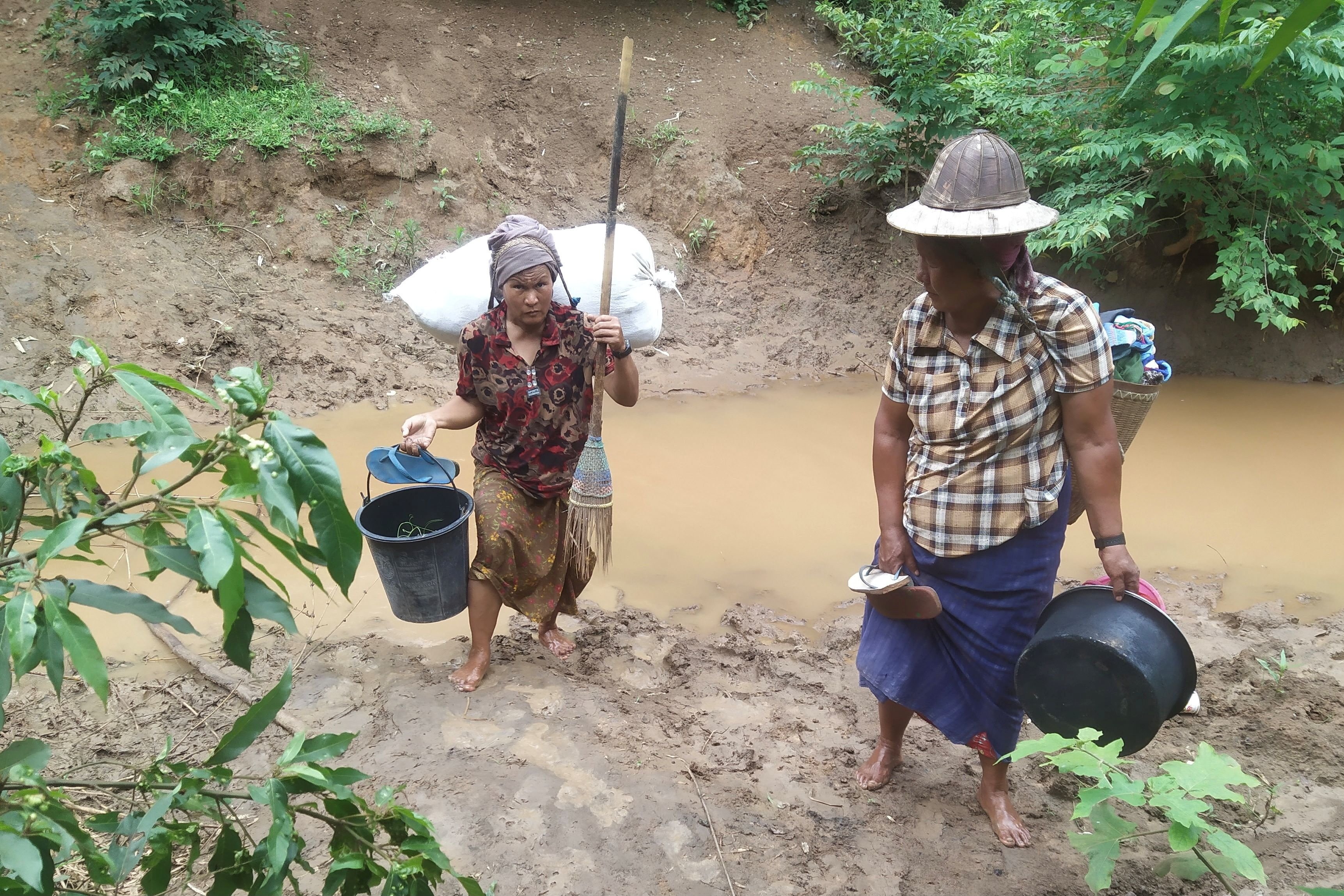 Villagers displaced by fighting in eastern Myanmar cross a river in Kayah state June 12, 2021. (CNS photo/Reuters)