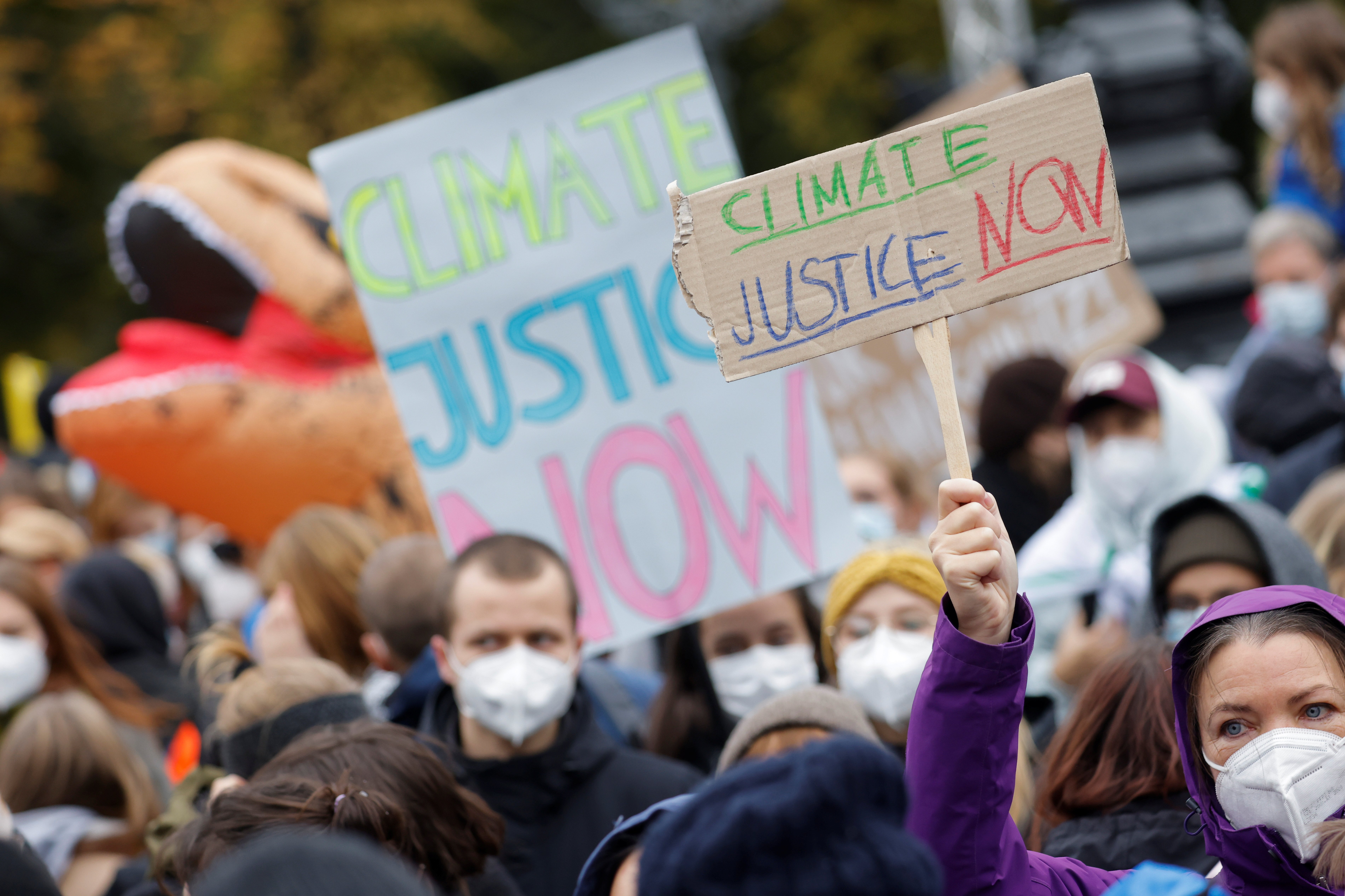 125-page report describes progress on environmental protection and difficulties faced by parishes and other church institutions in responding to climate change. Demonstrators hold signs during the Global Climate Strike of the movement Fridays for Future m