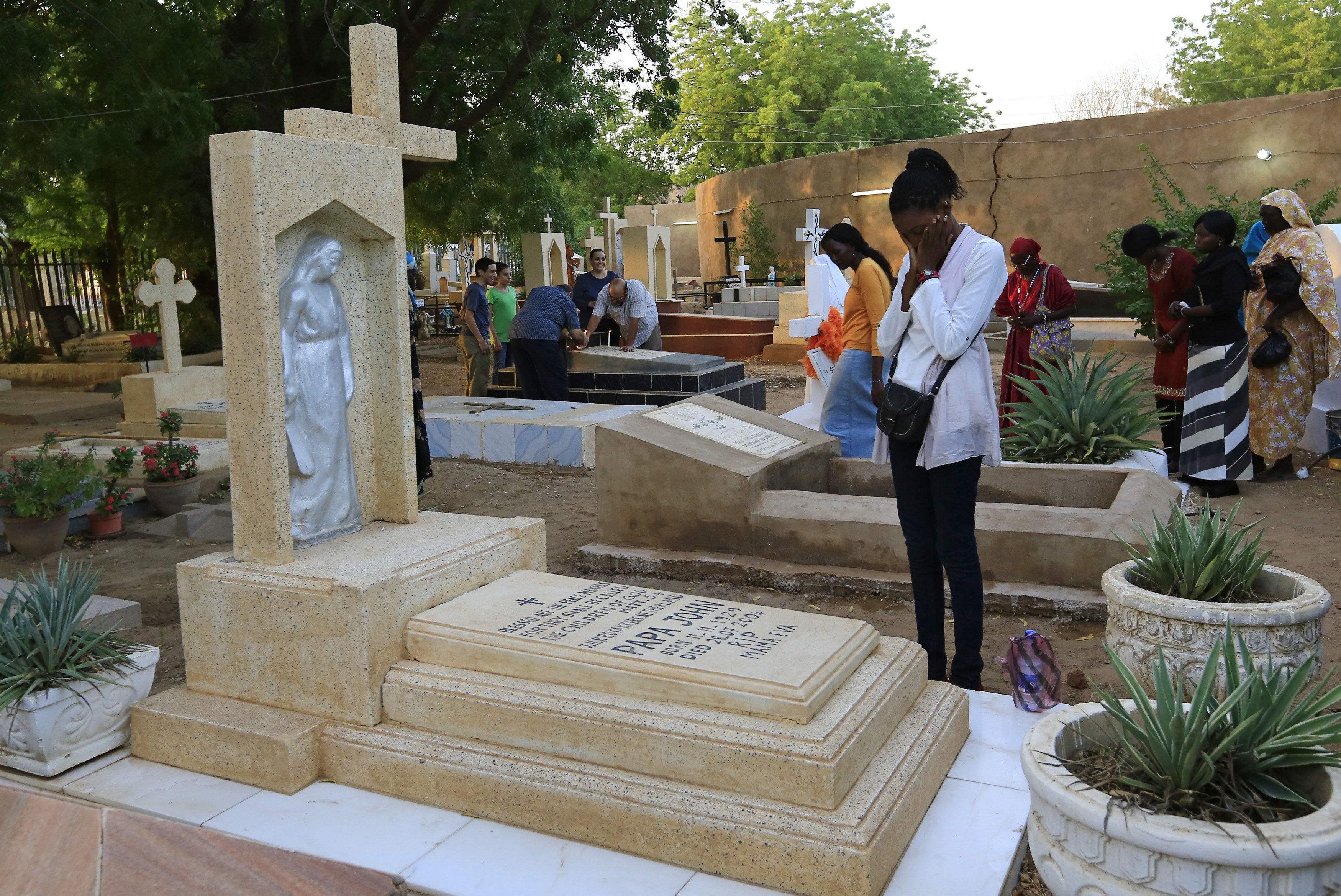 A family prays next to a relative's grave in a cemetery during All Souls' Day in Khartoum, Sudan, in this Nov. 11, 2014, file photo. (CNS photo/Mohamed Nureldin Abdallah, Reuters)