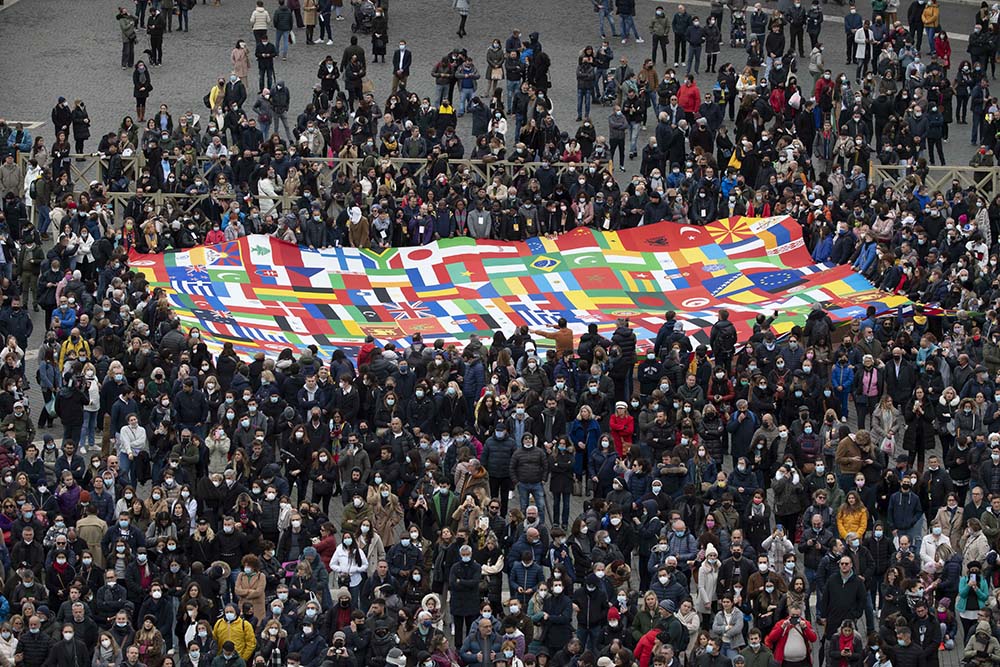 People in St. Peter's Square at the Vatican attend the Angelus led by Pope Francis from the window of his studio overlooking the square Nov. 28, 2021. (CNS/Vatican Media)