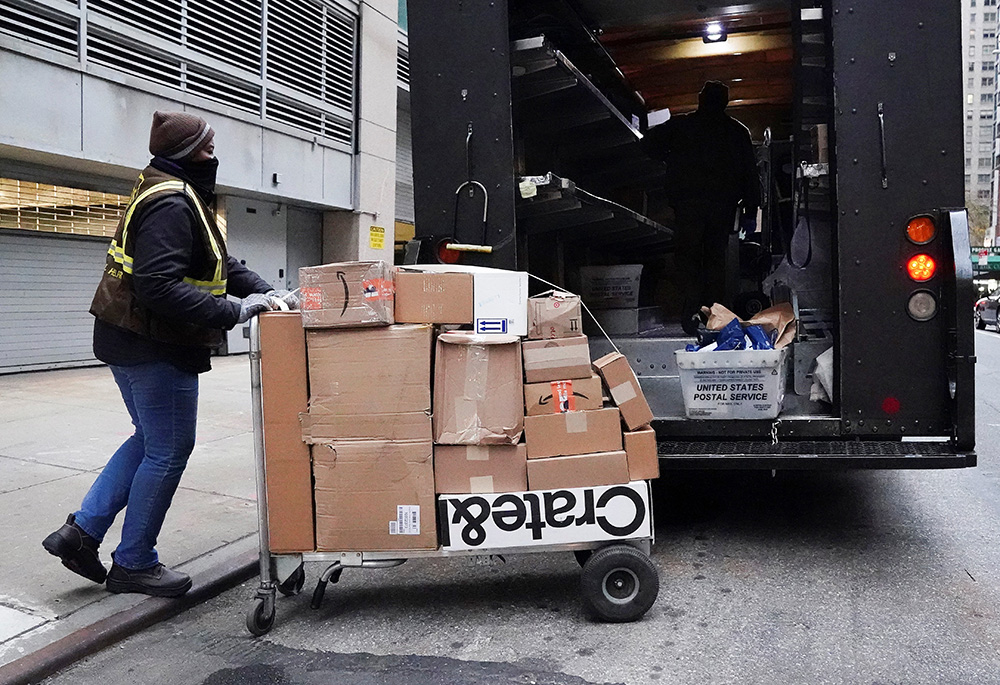 A UPS worker in New York City transports packages on Black Friday Nov. 26, 2021. (CNS/Reuters/Carlo Allegri)