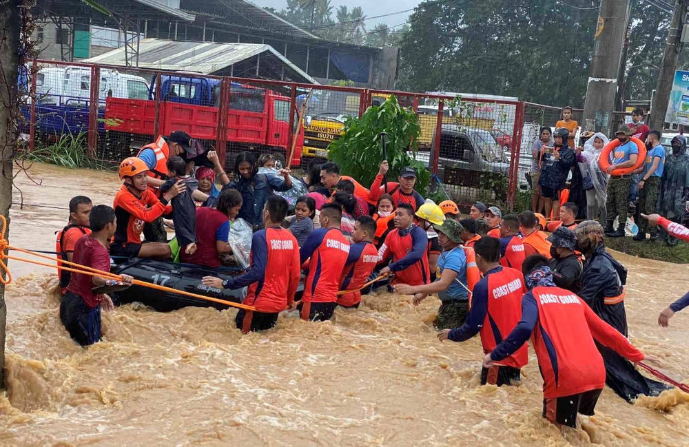 Philippine Coast Guard personnel rescue residents stranded by floods caused by Typhoon Rai in Cagayan de Oro, Philippines, Dec. 16, 2021. As of Dec. 21, the storm had claimed more than 370 lives. (CNS photo/Philippine Coast Guard handout via Reuters)