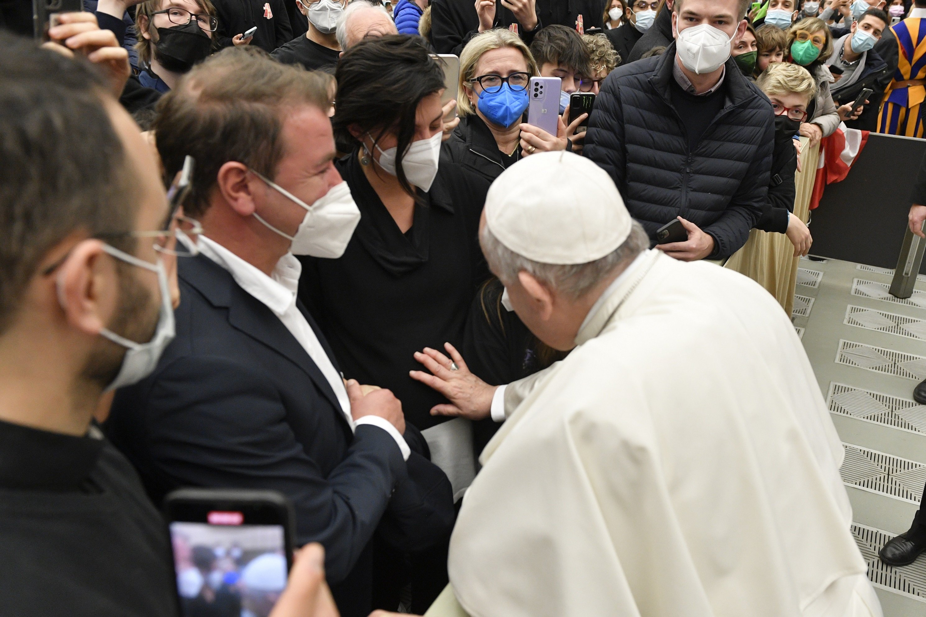 Pope Francis blesses a woman's unborn child at the end of his weekly general audience Dec. 29, 2021, in the Vatican's Paul VI hall. (CNS photo/Vatican Media)