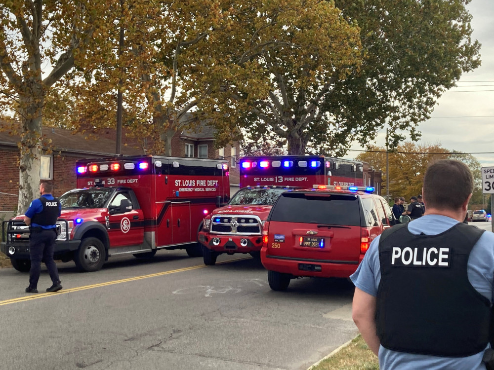 A view shows St. Louis Fire Department vehicles and a police officer