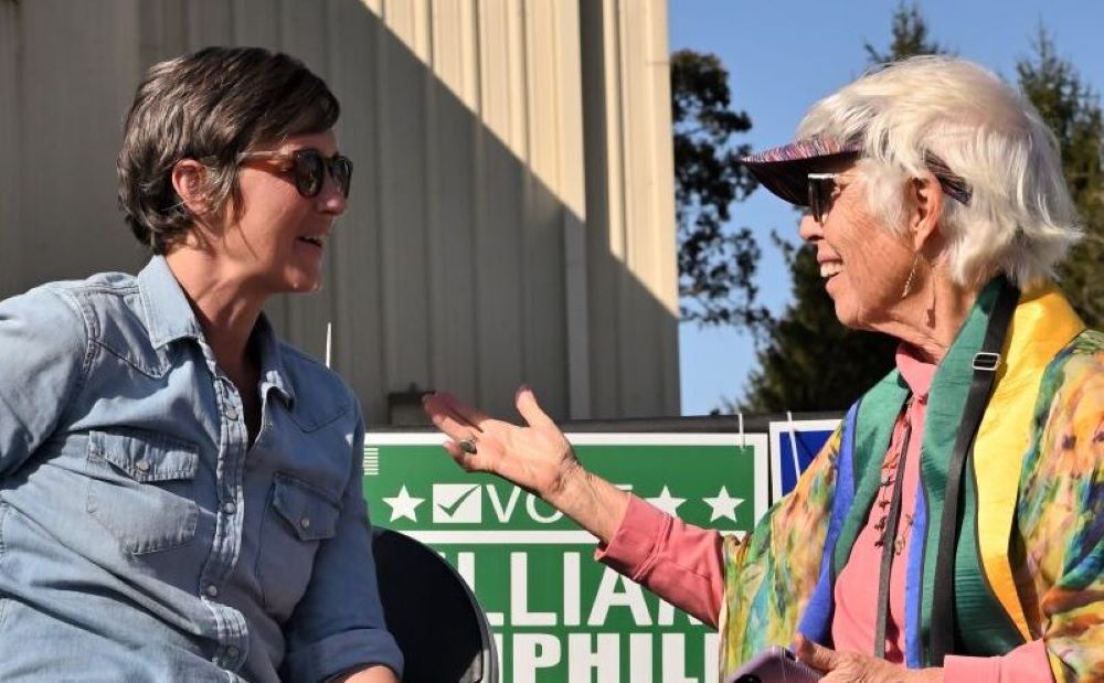 Carter Heyward talks with congressional candidate.