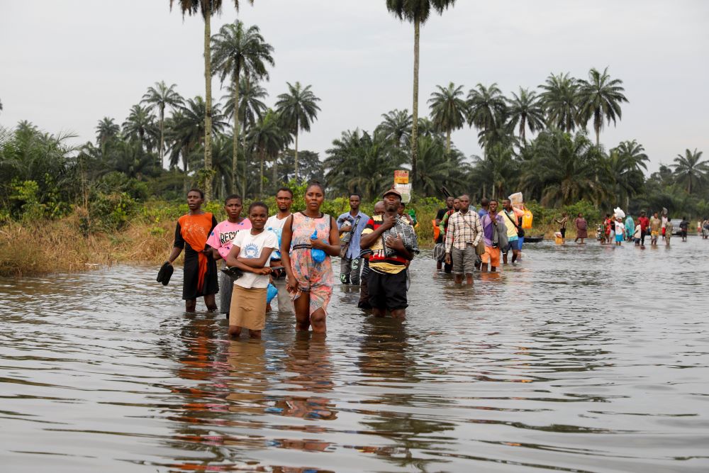 Residents wade through floodwaters in Obagi, Nigeria, Oct. 21, 2022. (CNS/Reuters/Temilade Adelaja)