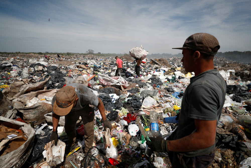 Waste recyclers look through heaps of waste for cardboard, plastic and metal, at a landfill in Buenos Aires, Argentina, Oct. 5. Among the challenges identified during the process of the Latin American church's First Ecclesial Assembly were social and economic inequalities exacerbated by the pandemic. (CNS/Reuters/Agustin Marcarian)