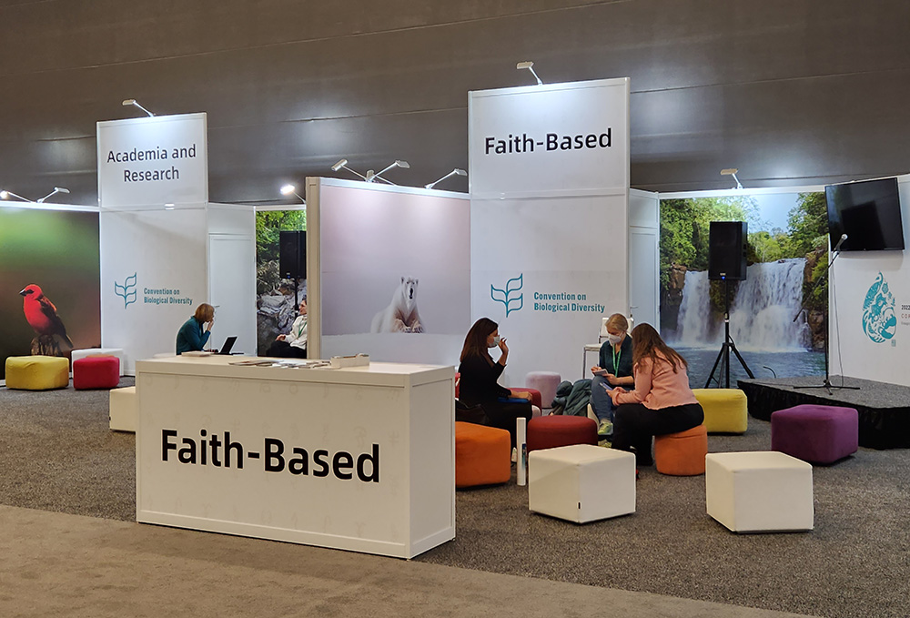 People take a break at the faith pavilion Dec. 11 at the COP15 United Nations biodiversity conference in Montreal. (NCR photo/Brian Roewe)