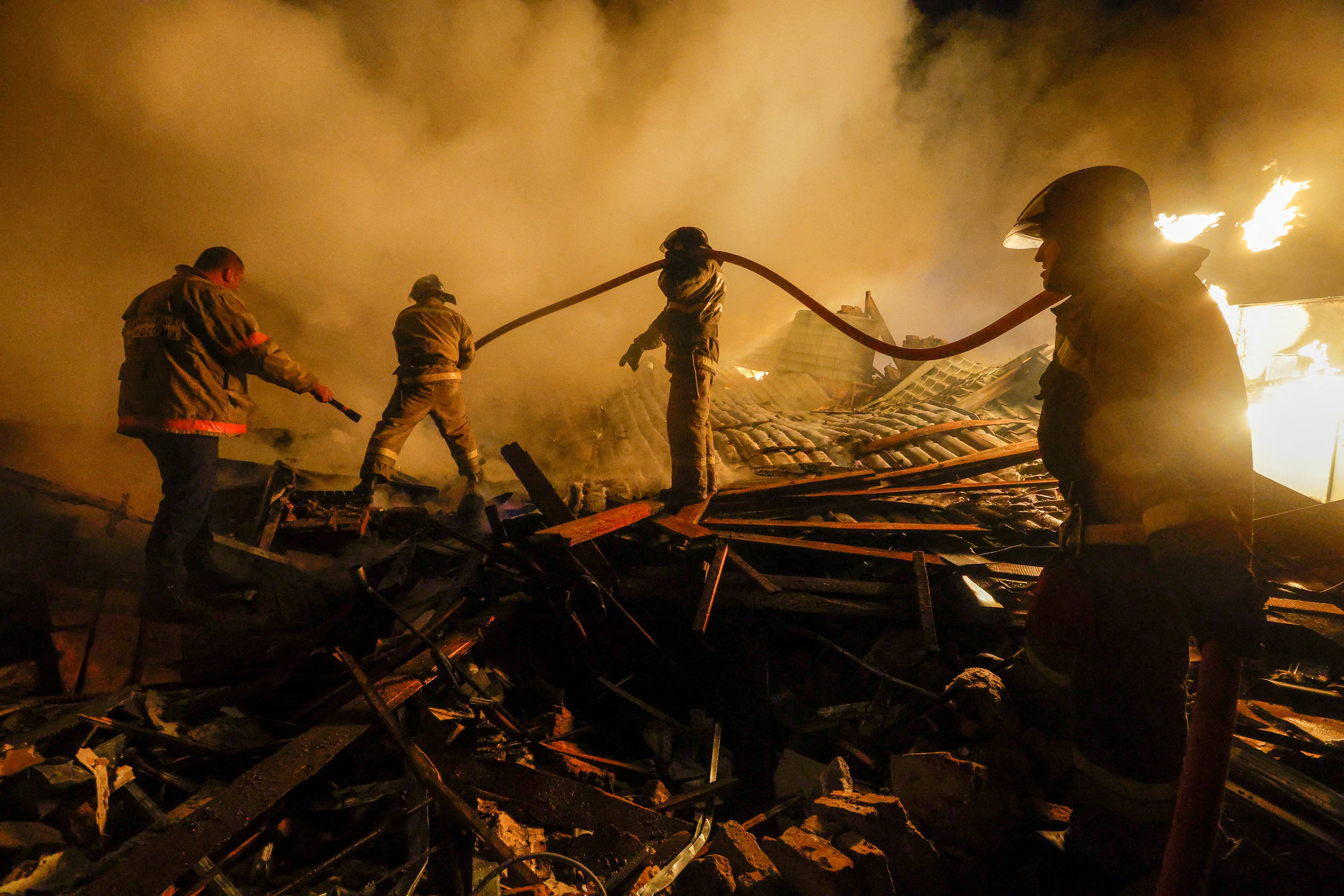 Firefighters work to extinguish fire amid debris of a residential building destroyed in shelling in Donetsk, Russian-controlled Ukraine, Dec. 9. (CNS/Reuters/Alexander Ermochenko)