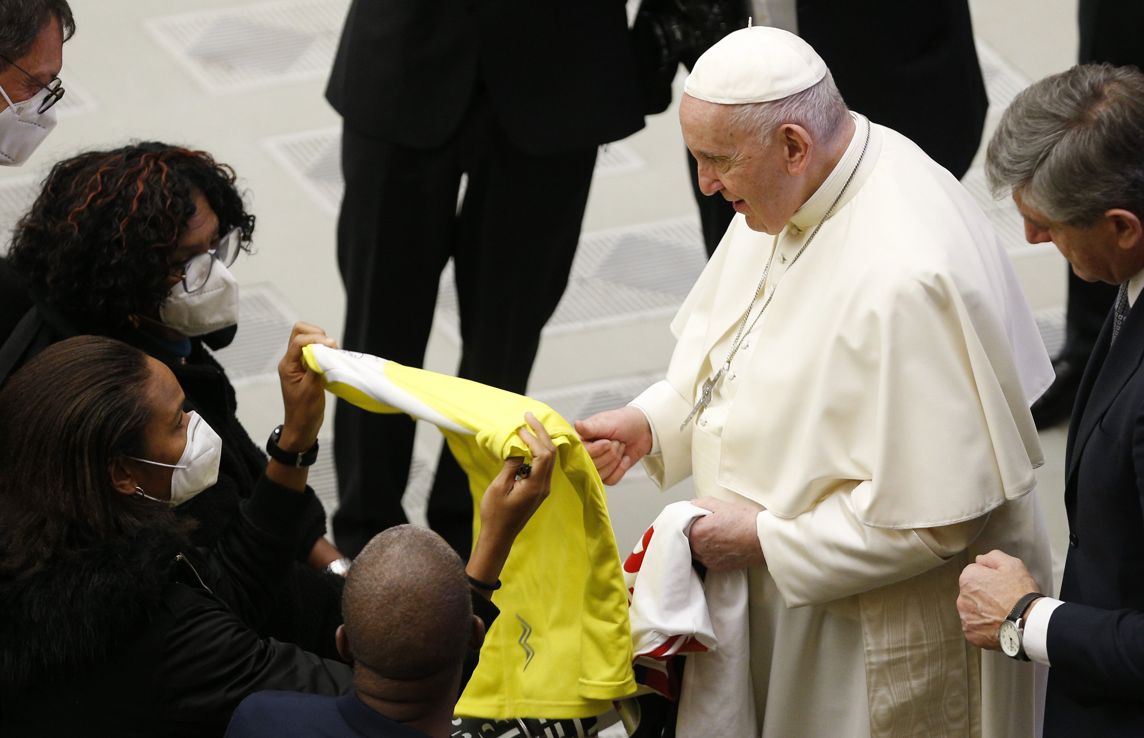 Pope Francis accepts a Vatican Athletic team jersey from Wendie Renard, a French professional soccer player for the Olympique Lyonnais Féminin club, during his general audience in the Paul VI hall at the Vatican Jan. 12, 2022. (CNS photo/Paul Haring)