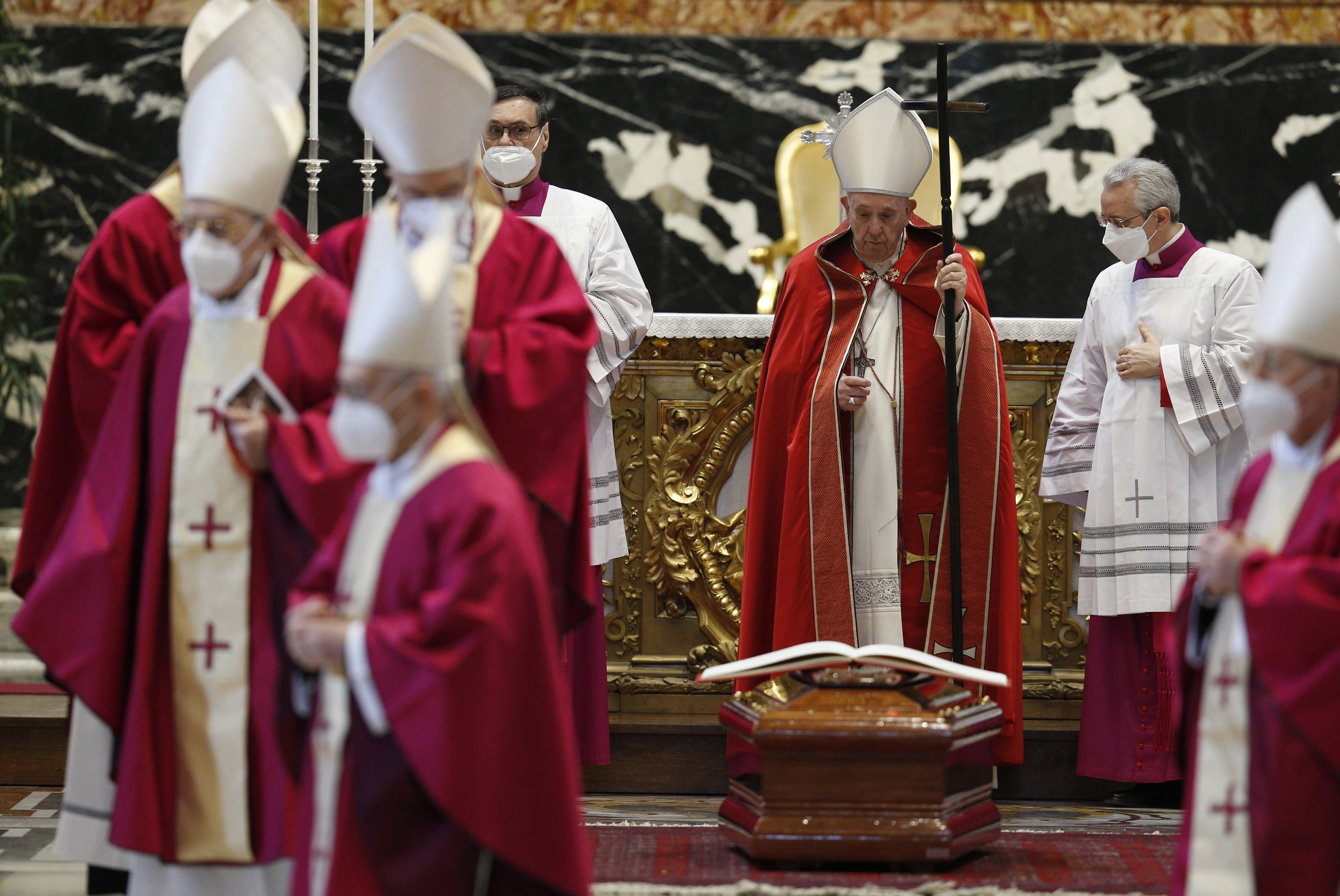 Pope Francis stands at the casket of Italian Cardinal Agostino Cacciavillan after leading the rite of final commendation during the cardinal's funeral Mass in St. Peter's Basilica at the Vatican March 7, 2022. (CNS photo/Paul Haring)