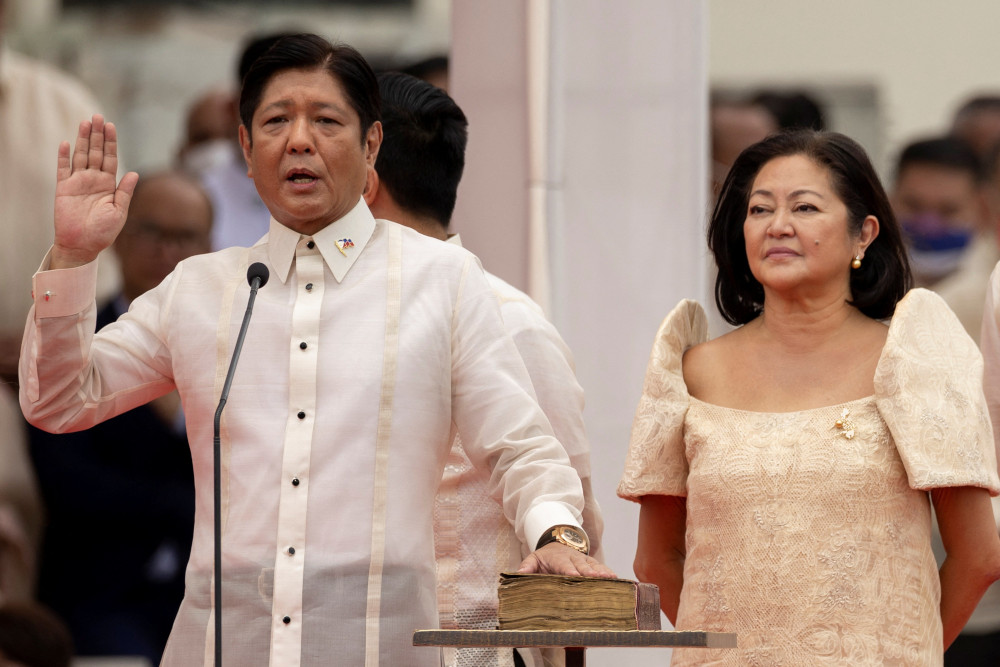 Ferdinand "Bongbong" Marcos Jr., the son and namesake of the late dictator Ferdinand Marcos, takes the oath of office beside his wife, Louise Araneta-Marcos, during the presidential inauguration ceremony at the National Museum in Manila, Philippines.