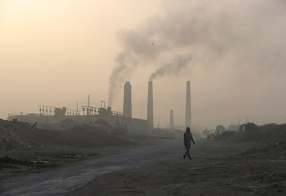 A general view shows brick factories as smoke rises from the stacks in the town of Nahrawan June 5 in Baghdad, Iraq. (CNS/Reuters/Thaier al-Sudani)