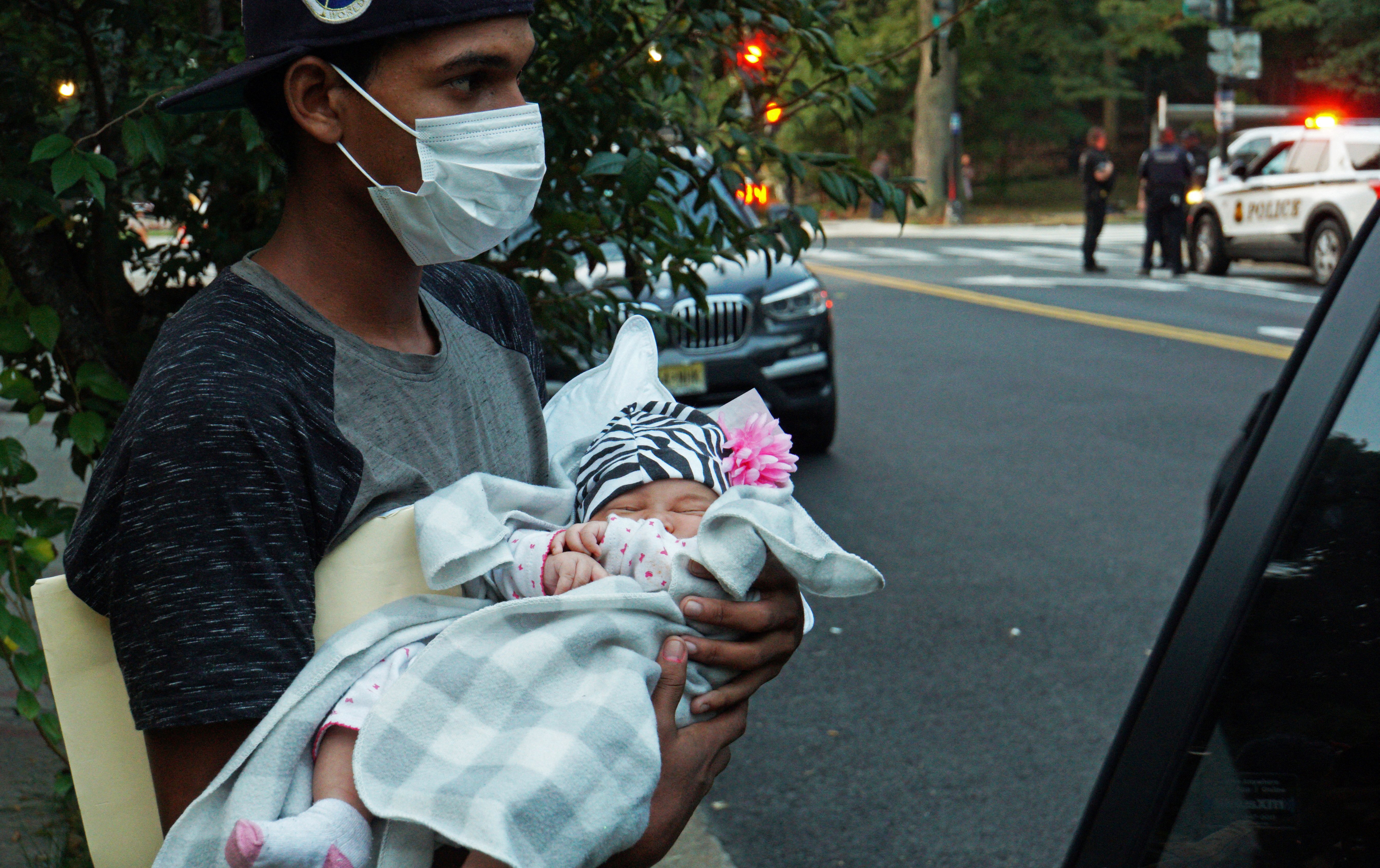 A 1-month-old baby is placed into a vehicle for transport to a safe place in Washington Sept. 17, 2022. after a group of mainly Venezuelan migrants arrived by bus from detention in Texas and were dropped off outside the Naval Observatory