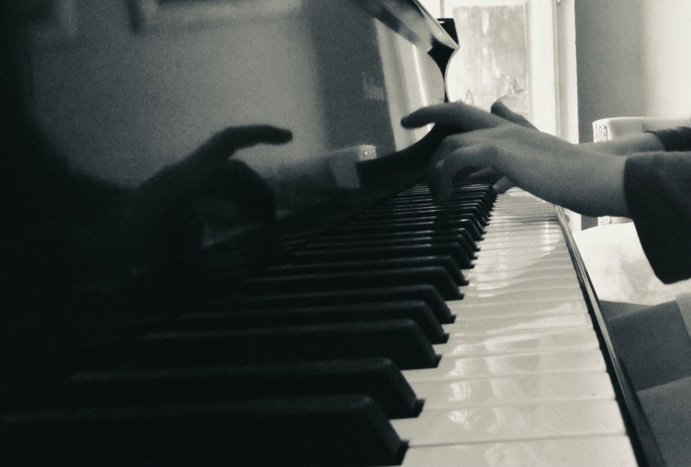 close-up of hands on a piano