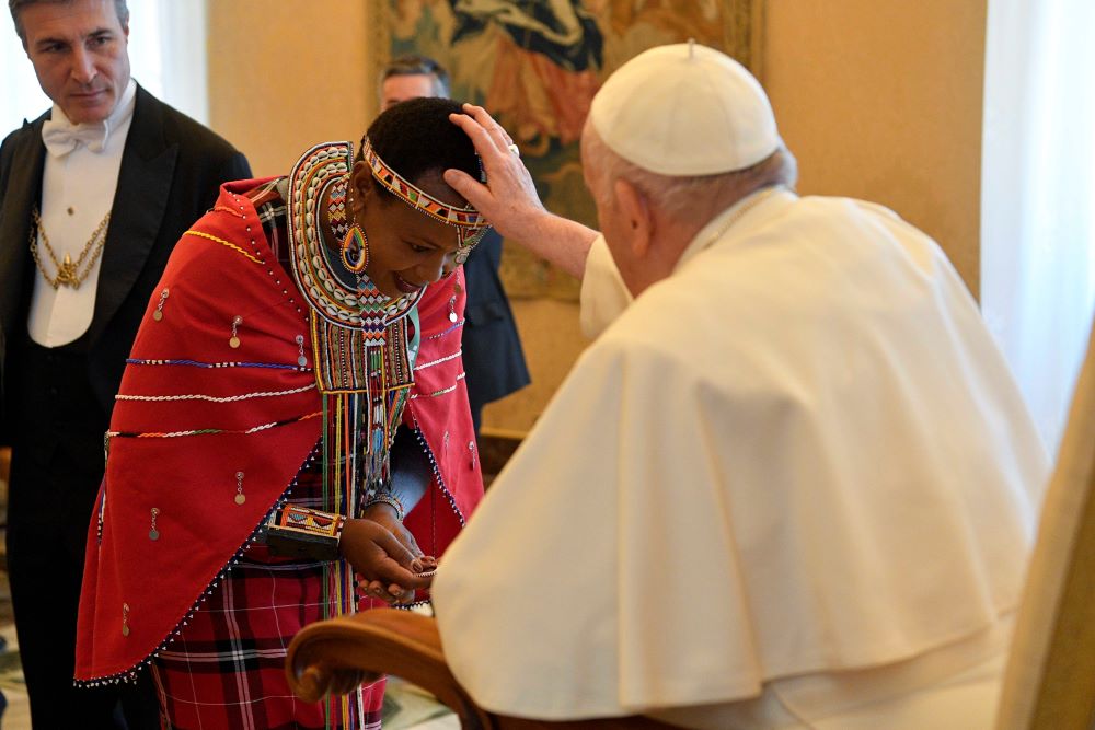 Pope Francis blesses a participant from the International Fund for Agricultural Development's Indigenous Peoples' Forum during an audience at the Vatican Feb. 10, 2023. (CNS photo/Vatican Media)