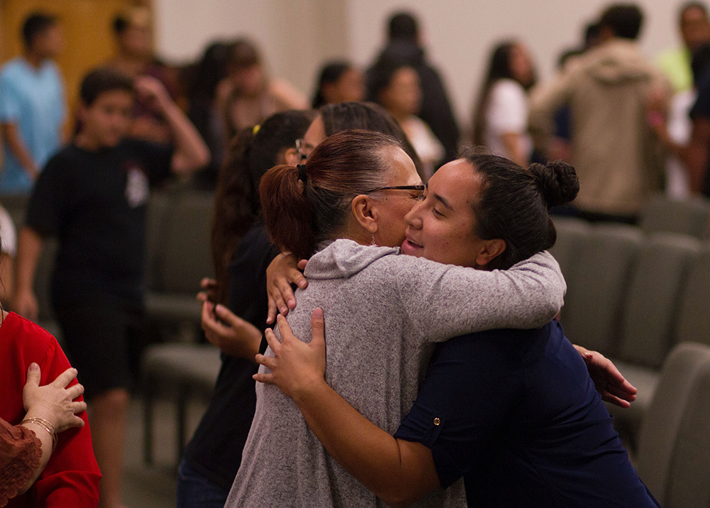 People hugging among other people greeting each other (Unsplash/Erika Giraud)