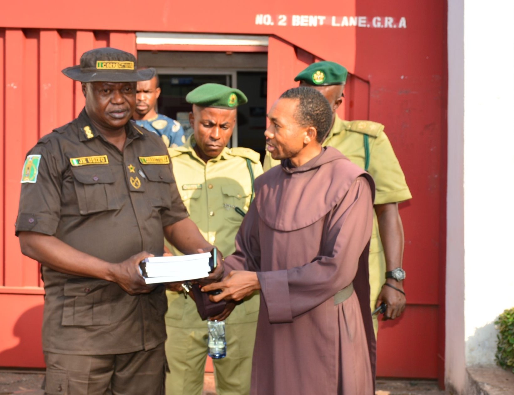 Carmelite Fr. Jude Isiguzo, Capio's executive director, meets with Joseph Usifo, deputy controller of Enugu Correctional Center. 