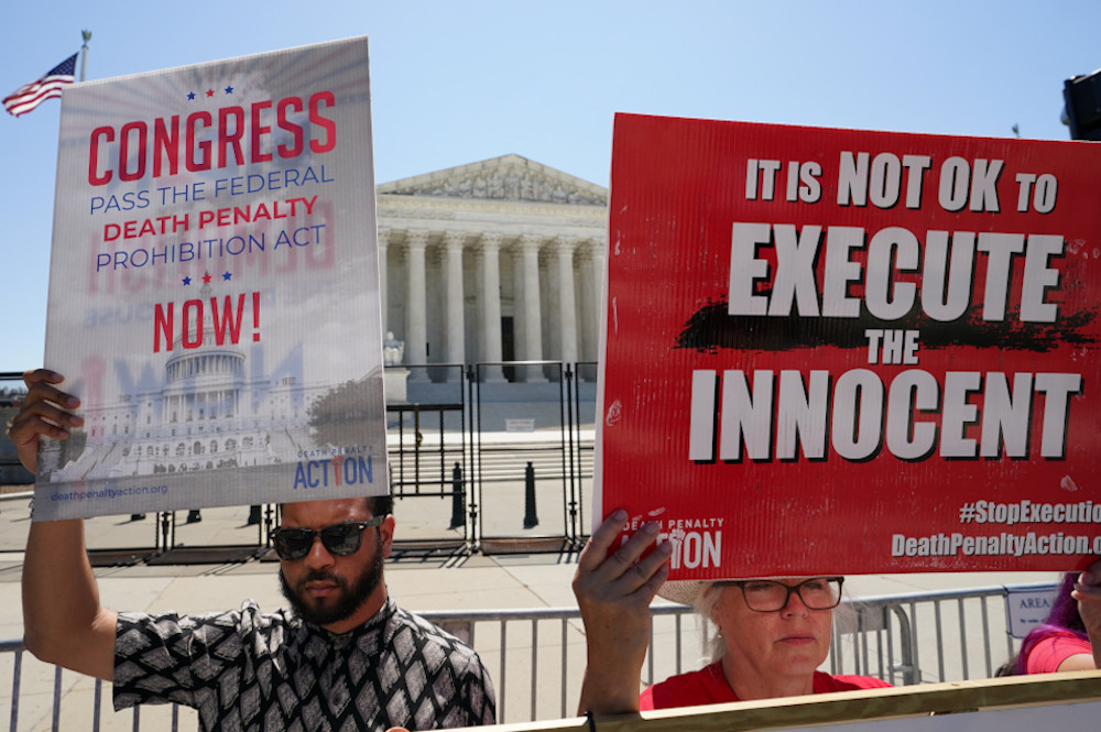 Demonstrators hold signs protesting capital punishment in front of the U.S. Supreme Court building in Washington, June 29, 2022. (OSV News/Reuters/Kevin Lamarque)