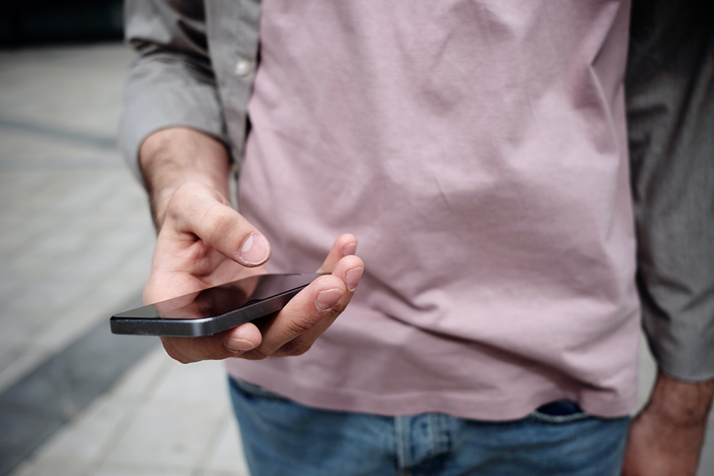 A person looks at a smartphone. (Unsplash/Clique Images)