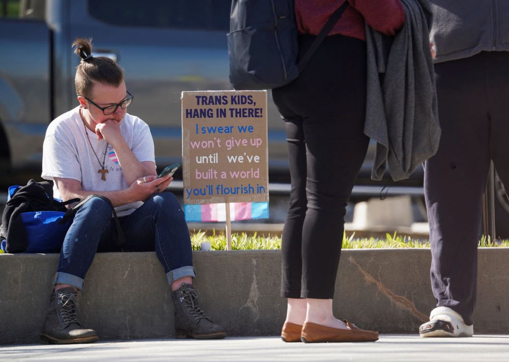 A young demonstrator sits during a protest rally outside the Georgia Capitol in Atlanta March 20.