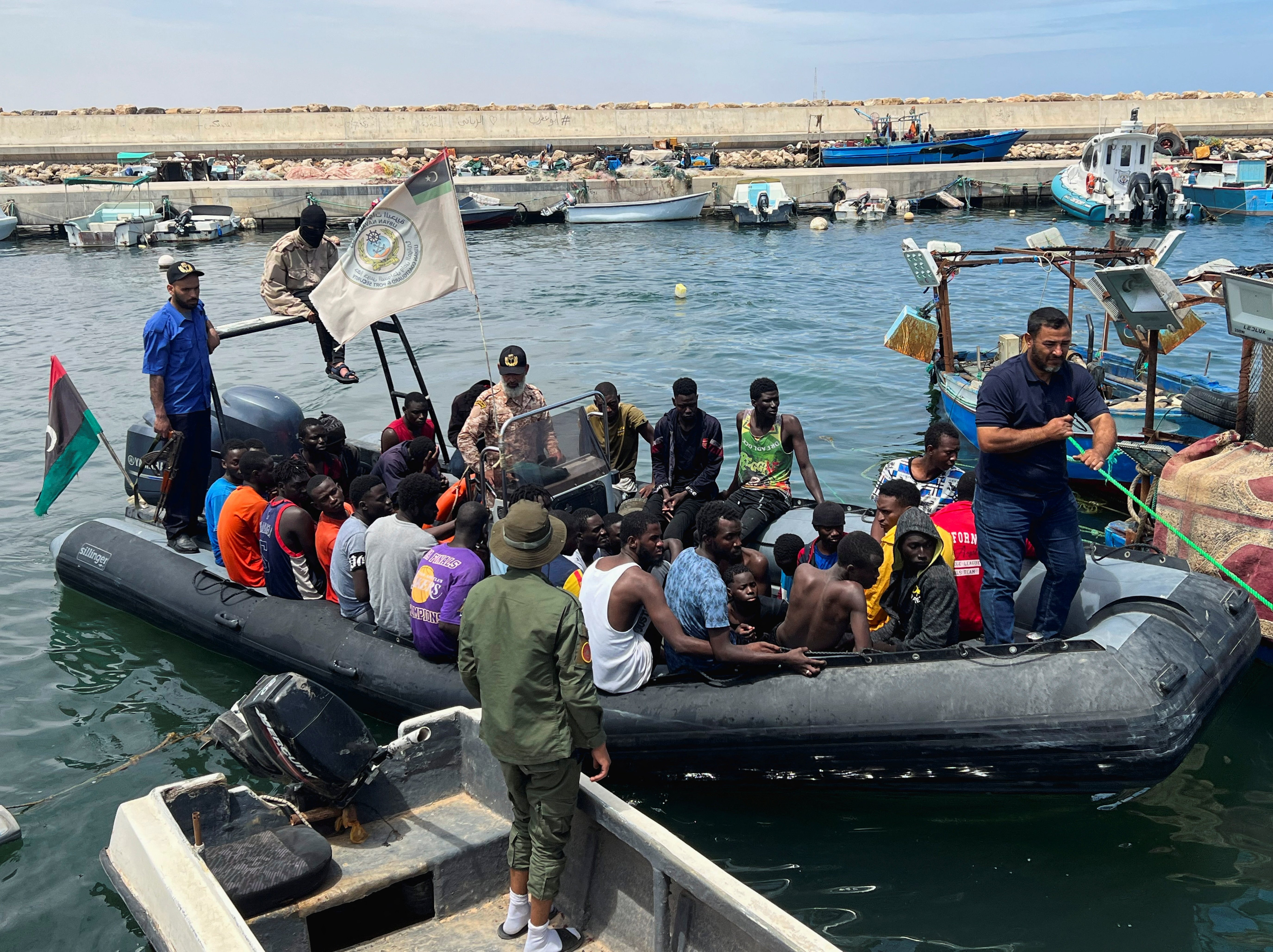 Migrants, whose boats sank in the sea and who were rescued by the Libyan Coast Guards at the Mediterranean Sea, arrive on a boat at the port in Garaboli, Libya, June 8. (OSV News/Reuters/Ayman al-Sahili)