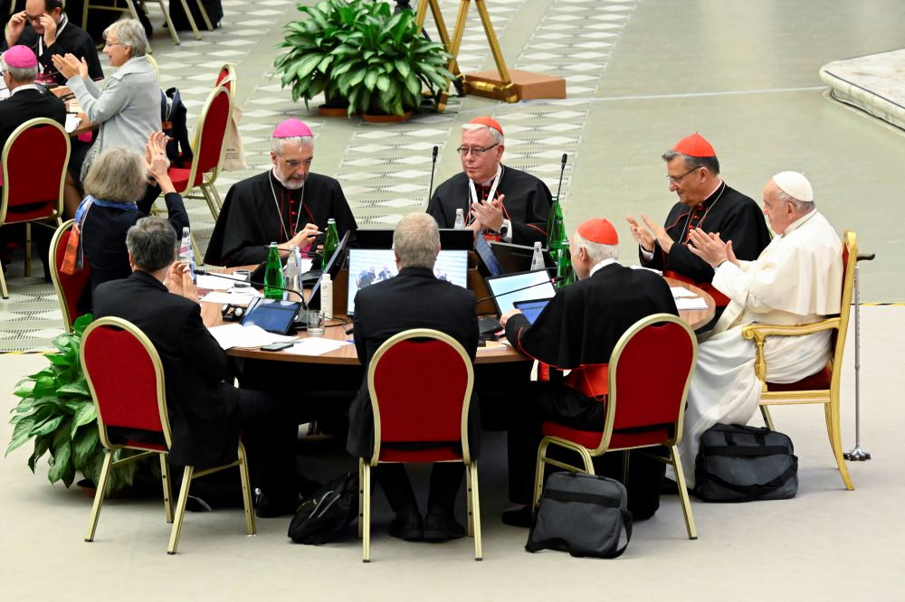 Pope Francis and leaders of the assembly of the Synod of Bishops applaud at the conclusion of the gathering's last working session Oct. 28 in the Paul VI Hall at the Vatican. (CNS/Vatican Media)