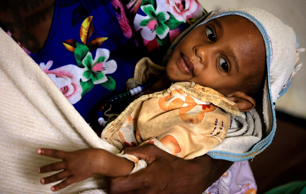 A mother carries her severely malnourished son at Samre Hospital in the Tigray region of Ethiopia June 23. (OSV News/Reuters/Tiksa Negeri)