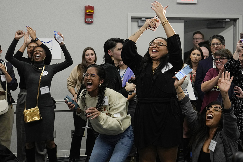 Issue 1 supporters celebrate as Rhiannon Carnes, executive director of the Ohio Women's Alliance, speaks at an election watch party Nov. 7 in Columbus. Ohio voters approved a constitutional amendment that guarantees the right to abortion and other forms of reproductive health care. (AP/Sue Ogrocki)